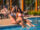 Two young woman relaxing by the pool