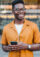 Young man smiling while holding a smart phone